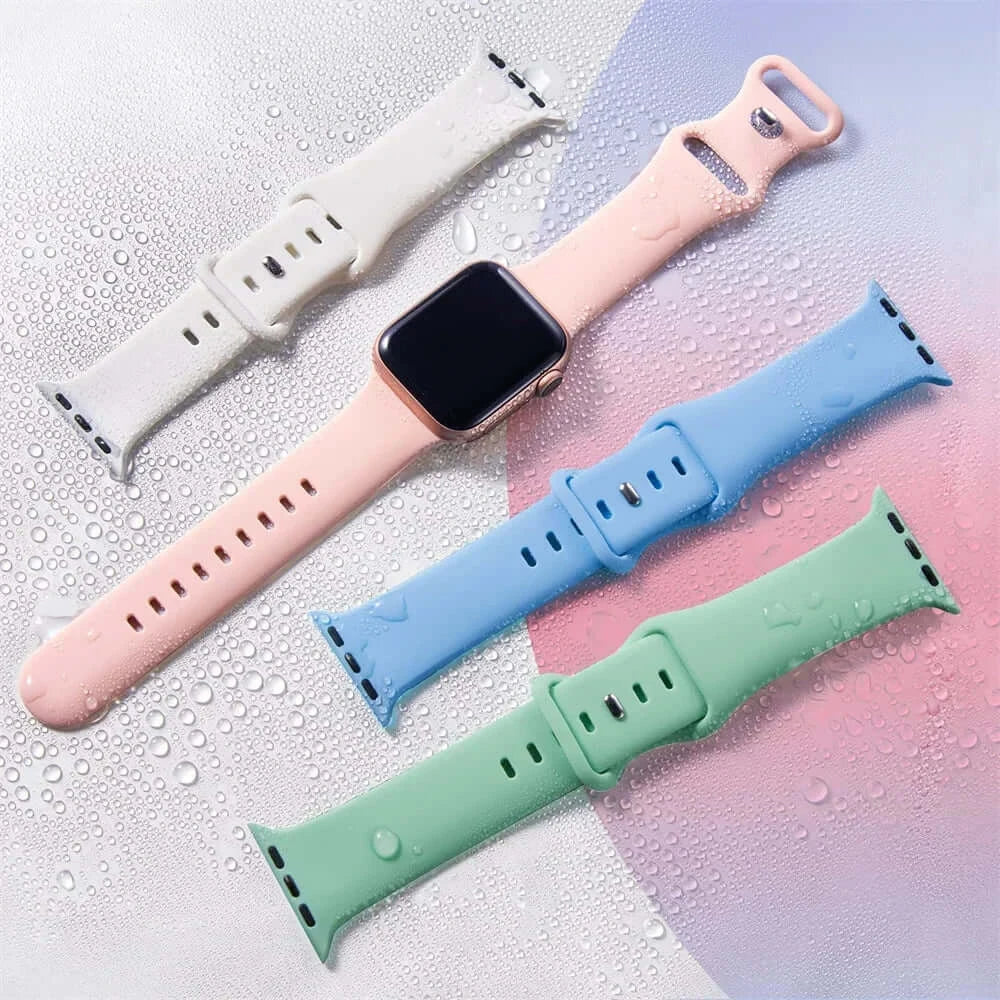 Pastel silicone Apple Watch straps displayed with water droplets