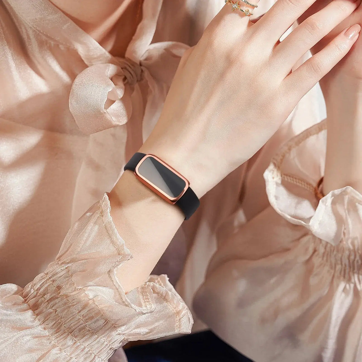 Elegant woman's wrist wearing a Fitbit Luxe case and screen protector, showcasing sophistication and style.