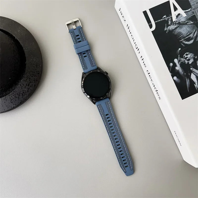 OnePlus Smartwatch Silicone Watch Band Breathable Sport Strap Replacement on a flat surface with a hat and book.
