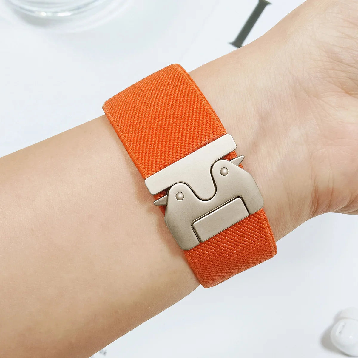 Garmin QuickFit Nylon Band - Clasp and Slider Styles orange nylon clasp band shown on a wrist