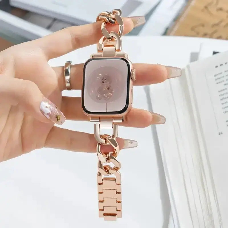 Rose Gold Apple Watch chain bracelet held in hand