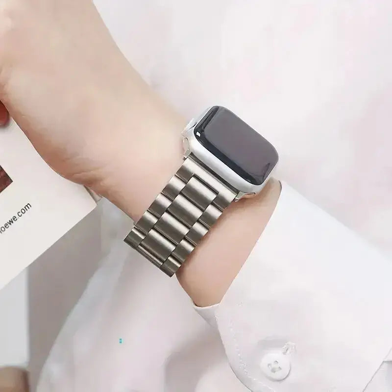 Silver wide-link Apple Watch bracelet worn on wrist