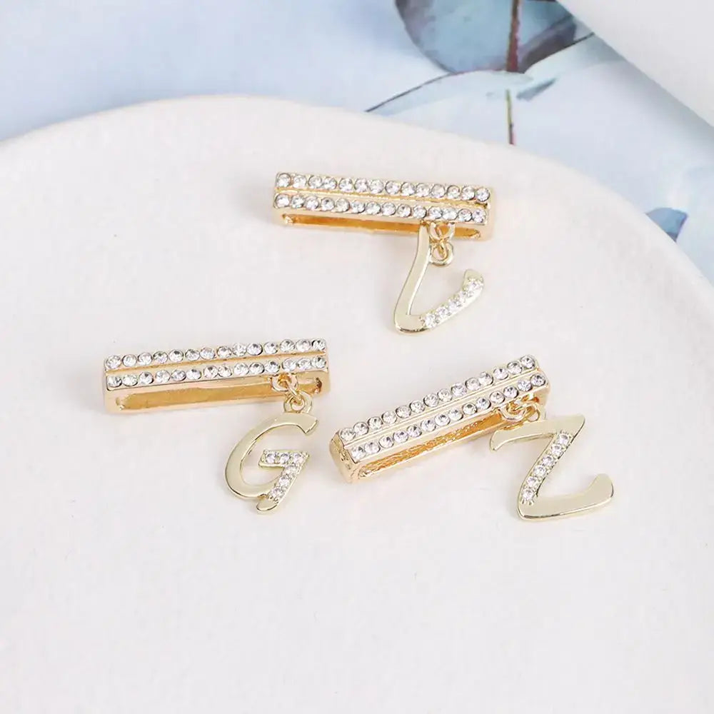 Decorative letter charms for Apple Watch band, featuring gold and rhinestone accents, perfect for style enthusiasts.