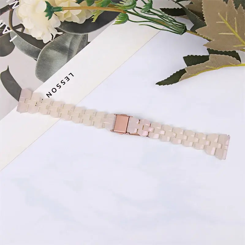 Ivory blush resin strap laid flat