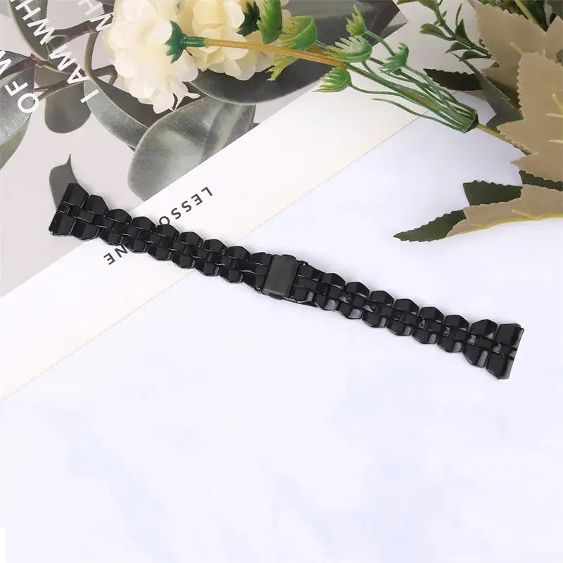 Black resin strap laid flat