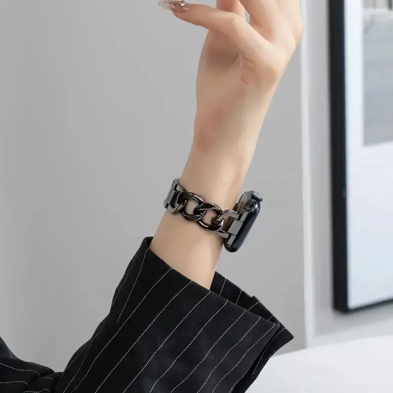 Black Apple Watch chain bracelet worn on wrist