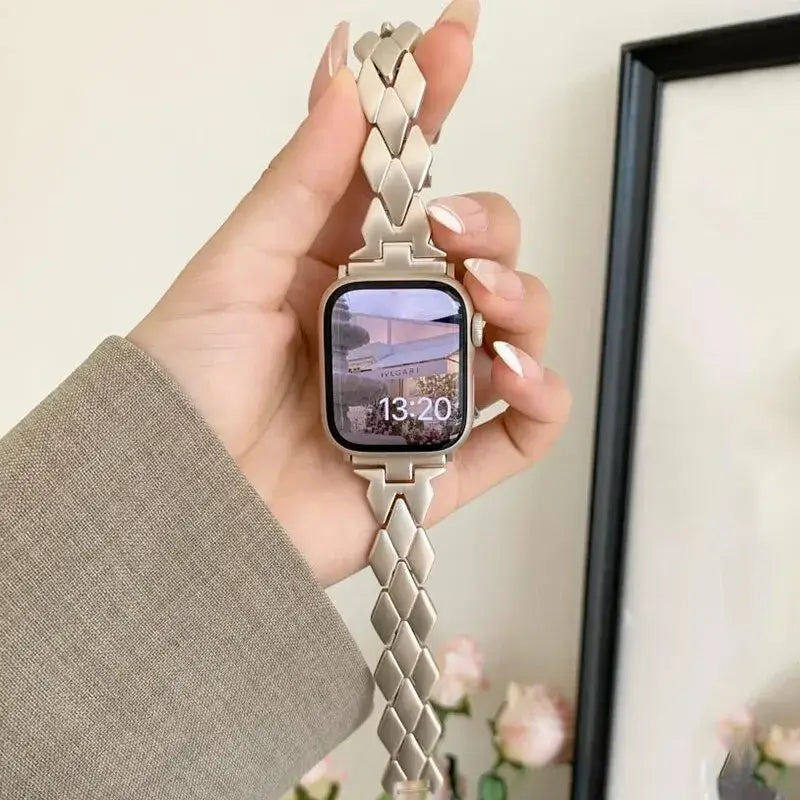 Full length of the Starlight herringbone stainless steel Apple Watch band.