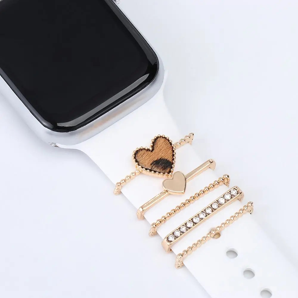 Decorative metal charms on an Apple Watch band, adding elegance and style to a smartwatch.