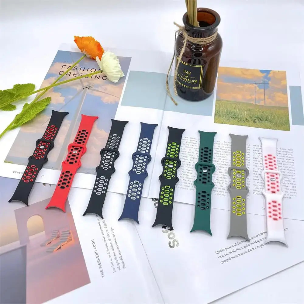 Eight perforated two-tone silicone Pixel Watch straps laid flat