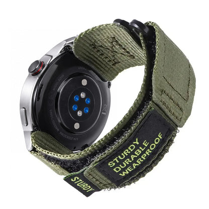 Olive nylon hook-and-loop band with black metal ring and original STURDY patch, fitted to an Amazfit watch