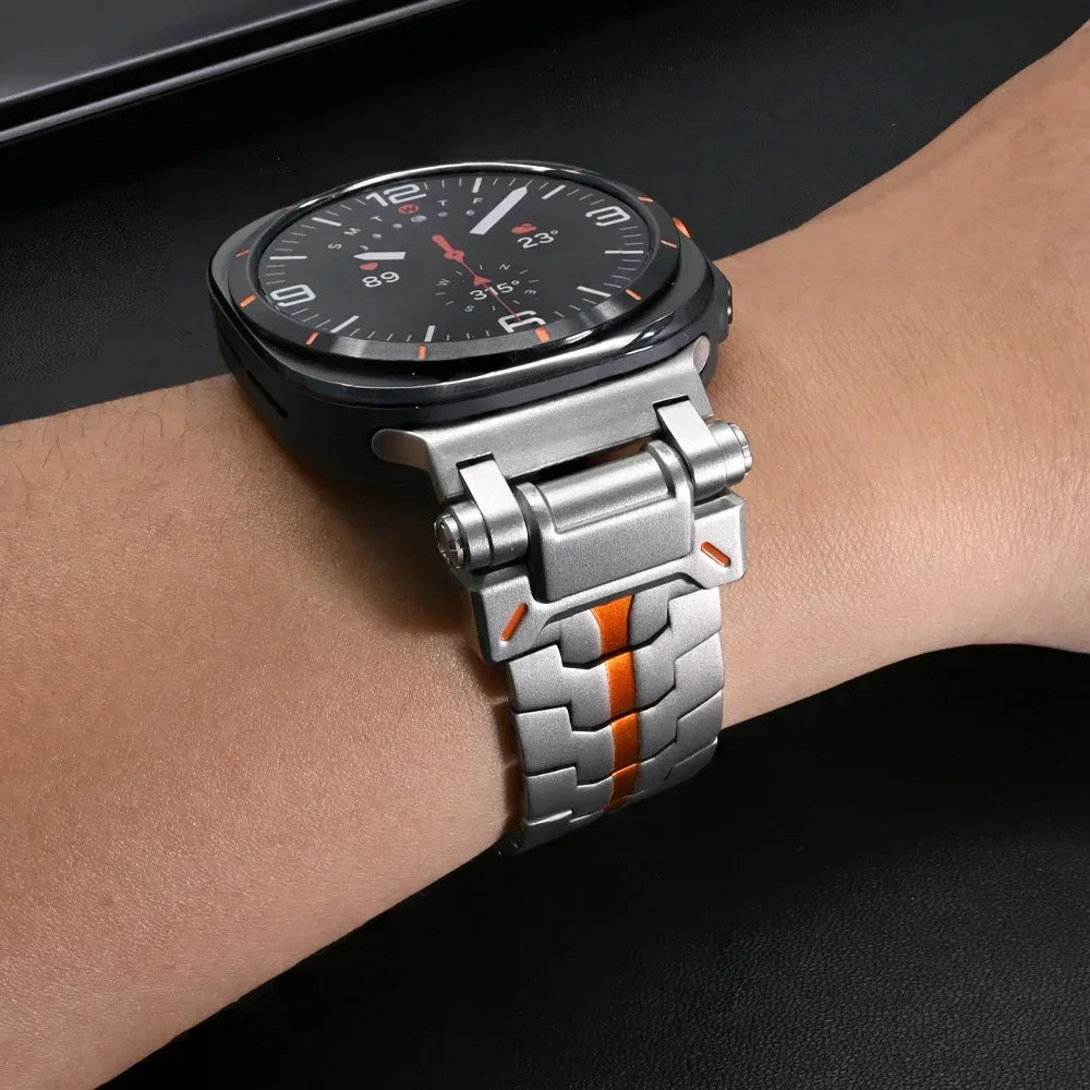 Steel link watch band with orange stripe worn on wrist for Samsung Galaxy Watch8, Watch8 Classic and Watch9