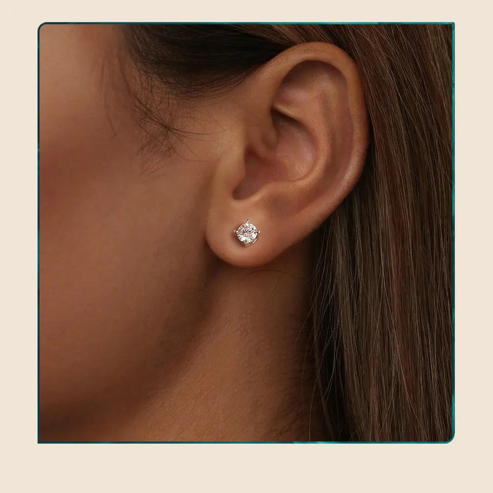 Round Moissanite Four-Prong Stud Earrings in Sterling Silver - Stud earrings on model