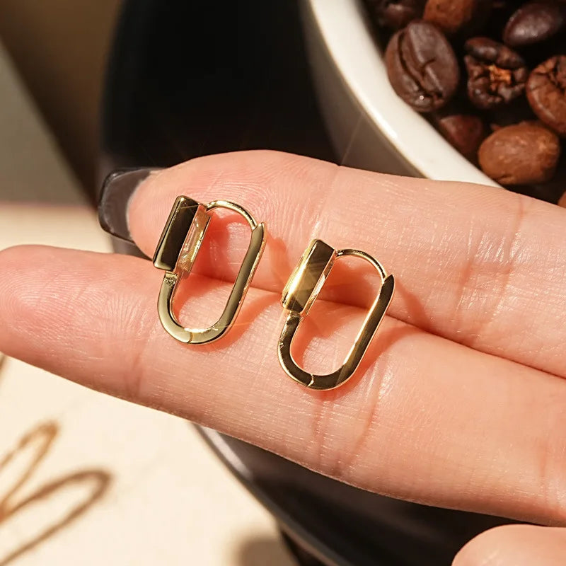 Emerald-Cut Moissanite Hoop Earrings in Sterling Silver — Gold-Tone hoops held for scale