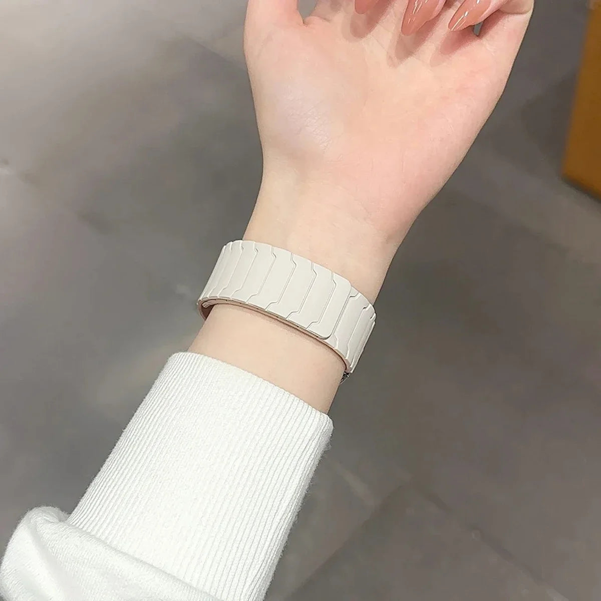 Ivory segmented magnetic band worn on wrist