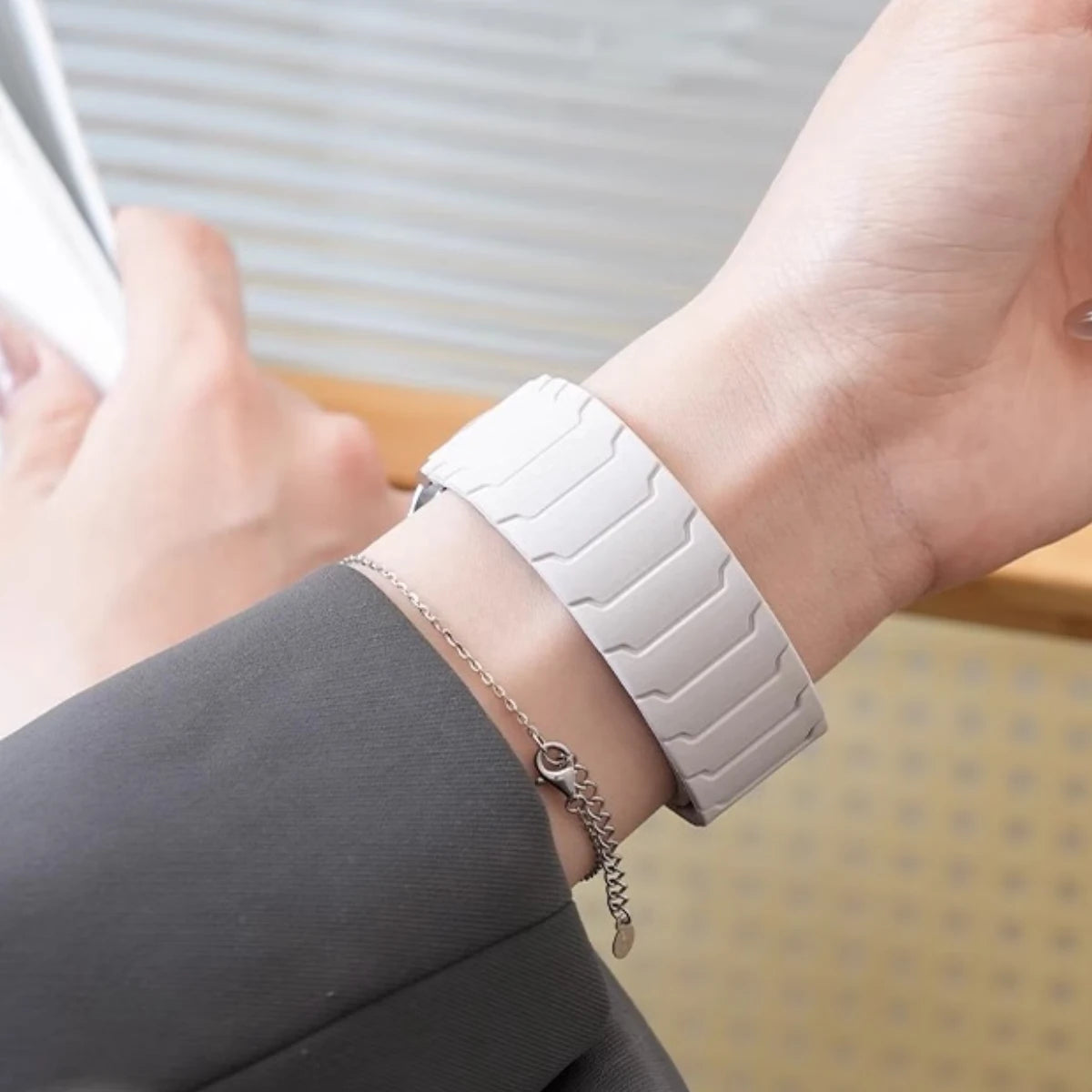 White segmented magnetic band worn on wrist