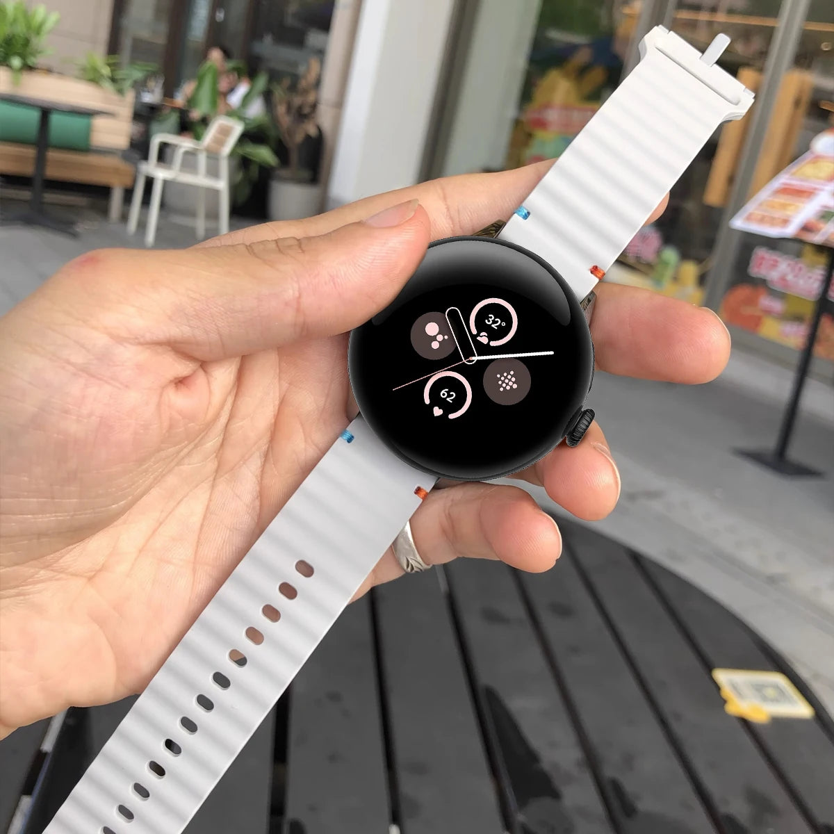 White ridged silicone strap being held