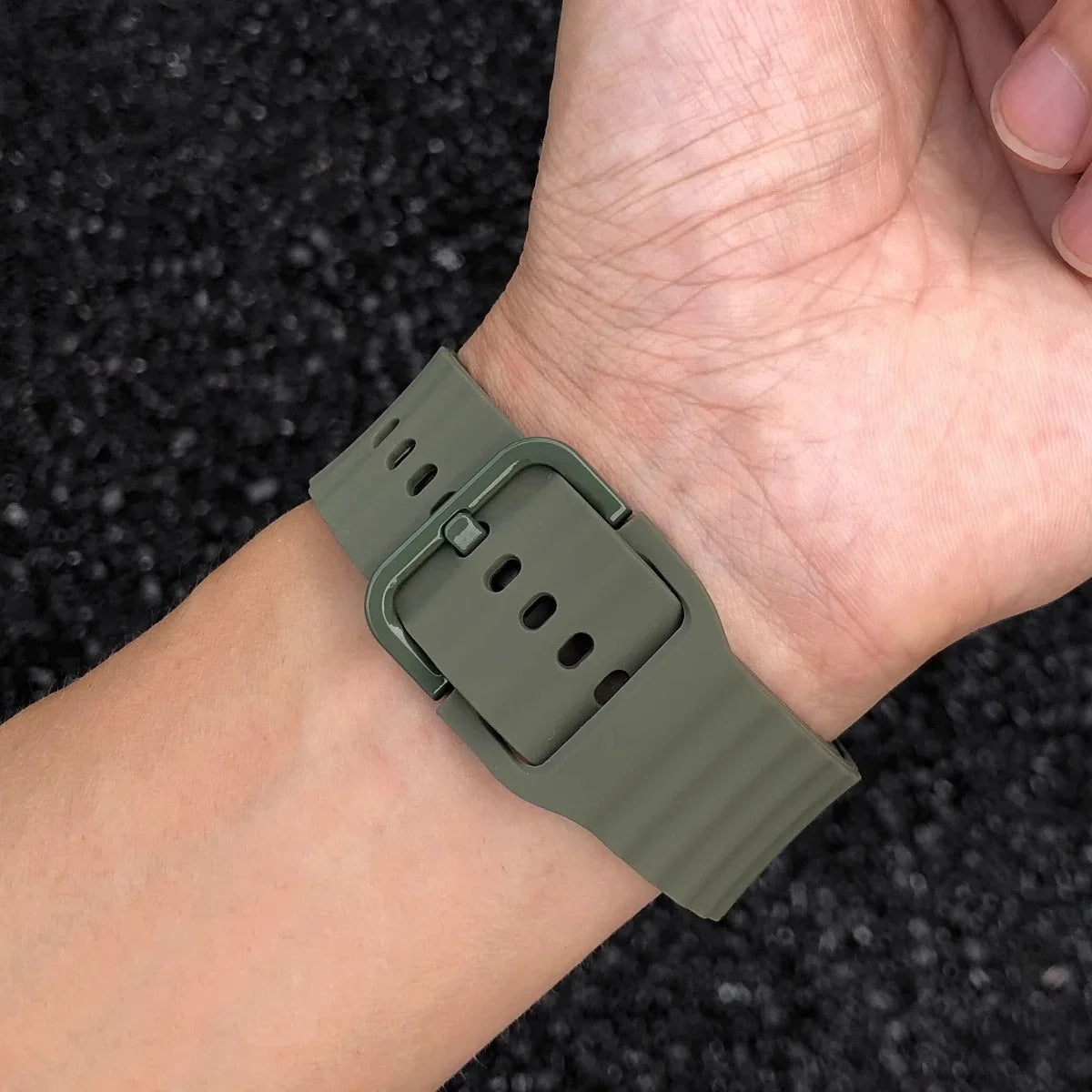 Army green ridged band and matching buckle worn on wrist