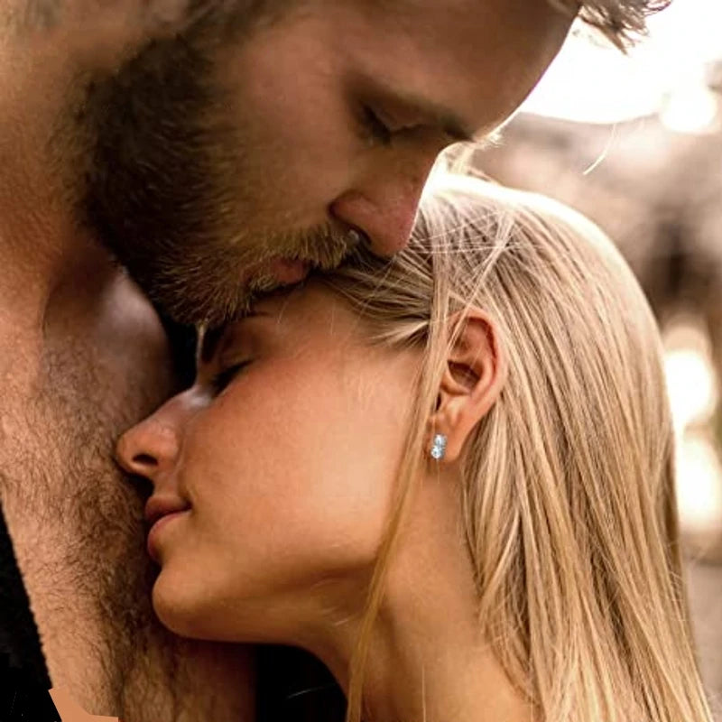 Graduated Two-Stone Moissanite Stud Earrings in Sterling Silver — Stud earrings styled on the ear