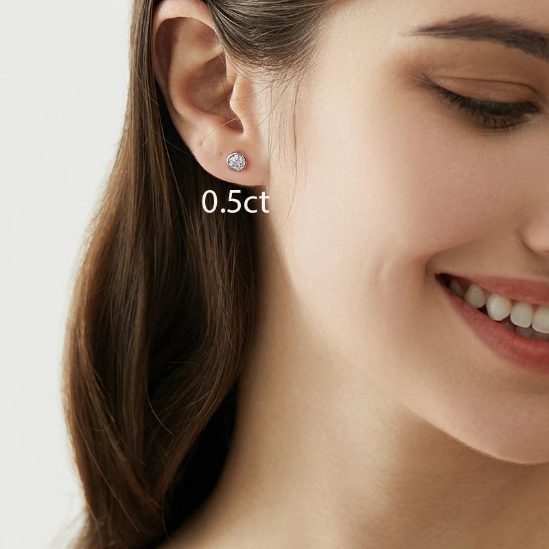 Round Bezel Moissanite Stud Earrings in Sterling Silver — Worn on ear