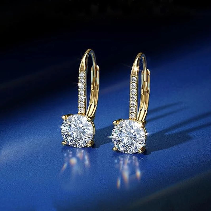 Moissanite Leverback Drop Earrings in Sterling Silver — Gold-tone drops on blue surface