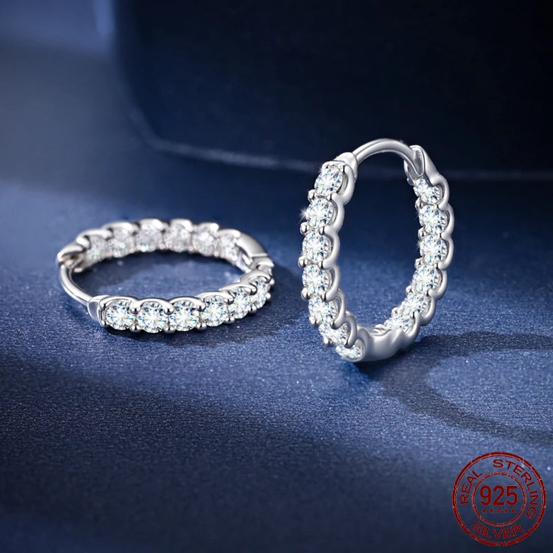 Moissanite Inside-Out Hoop Earrings in 925 Sterling Silver — Pair on dark blue surface