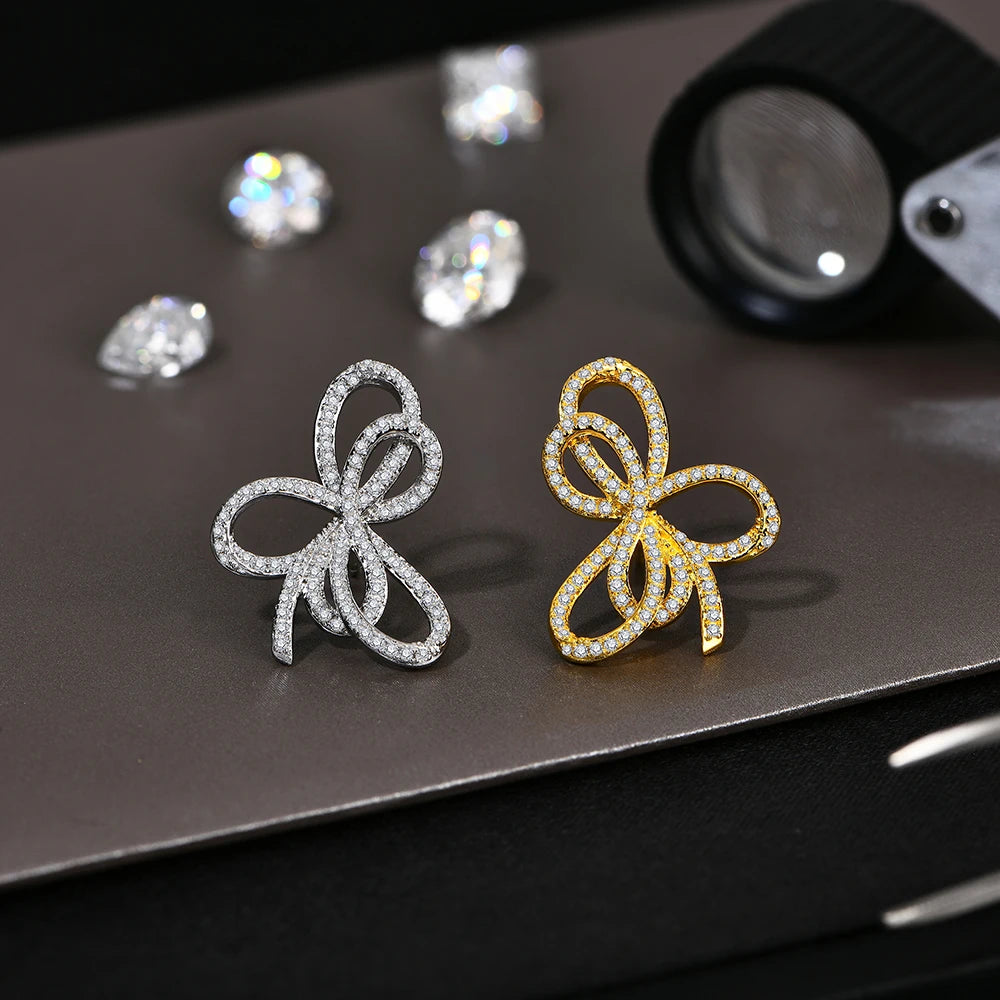 Open Bow Moissanite Stud Earrings in 925 Sterling Silver — Silver and gold-tone comparison