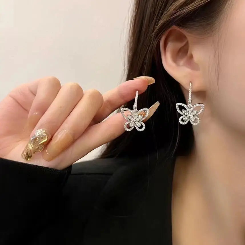 Openwork Butterfly Moissanite Drop Earrings in Silver — Worn on ear
