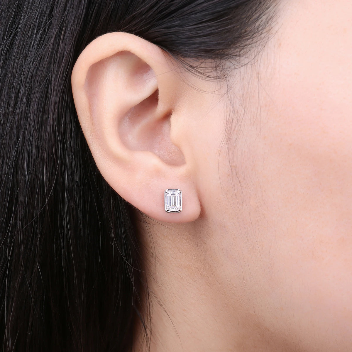 Emerald-Cut Moissanite Stud Earrings in Sterling Silver - Emerald-cut stud on model