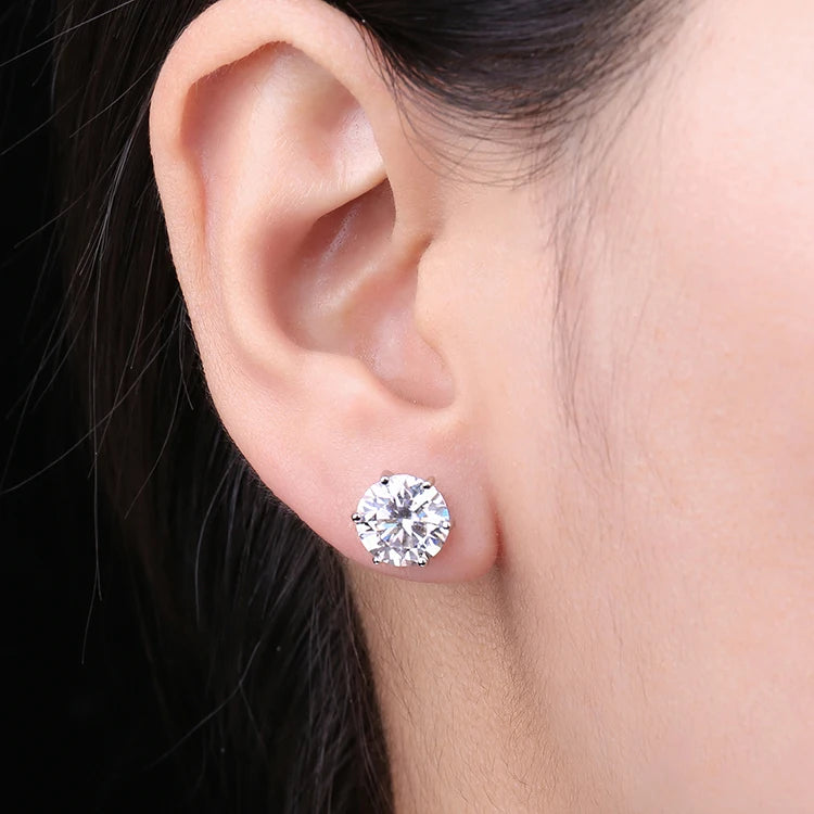 Round Moissanite Solitaire Stud Earrings in Three Metal Finishes — Shown on ear