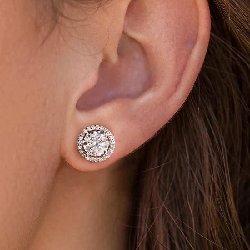Round Halo Moissanite Stud Earrings in 925 Sterling Silver — Shown on ear