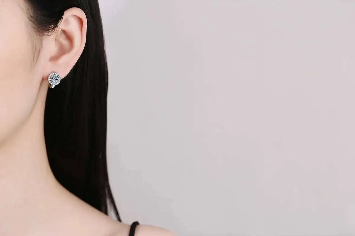 Round Halo Moissanite Hoop Earrings in 925 Sterling Silver — Shown on ear