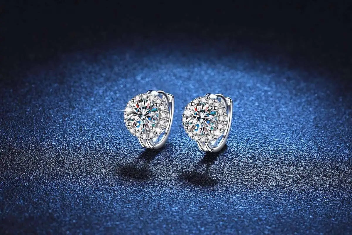 Round Halo Moissanite Hoop Earrings in 925 Sterling Silver — Pair on blue fabric