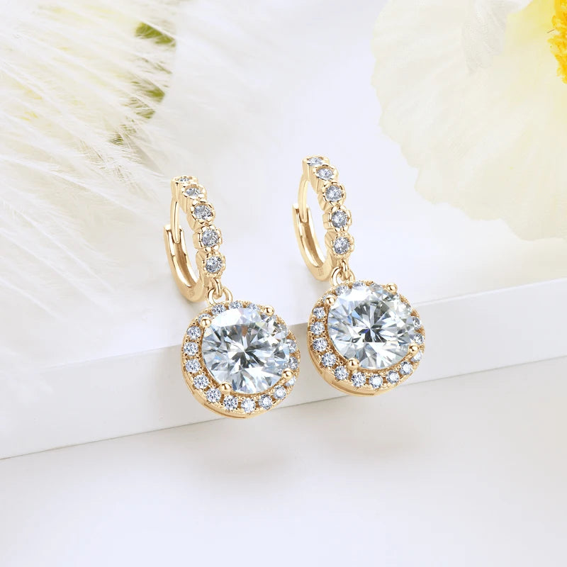 Round Halo Moissanite Huggie Drop Earrings in Sterling Silver — Gold-tone pair on fabric