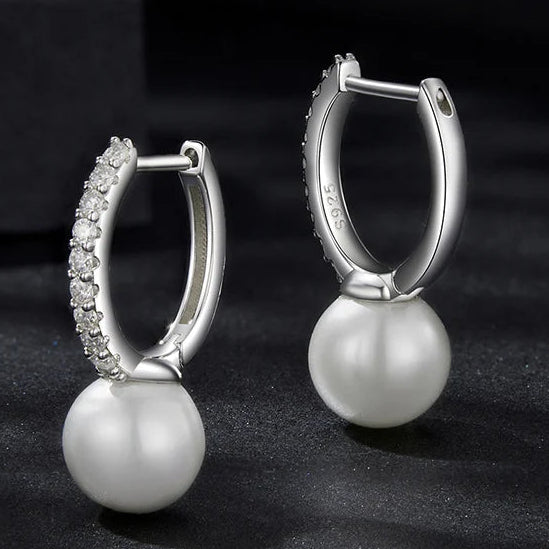 Moissanite Shell Pearl Drop Hoop Earrings in Sterling Silver — Pearl hoops on dark display — BandsCo Straps