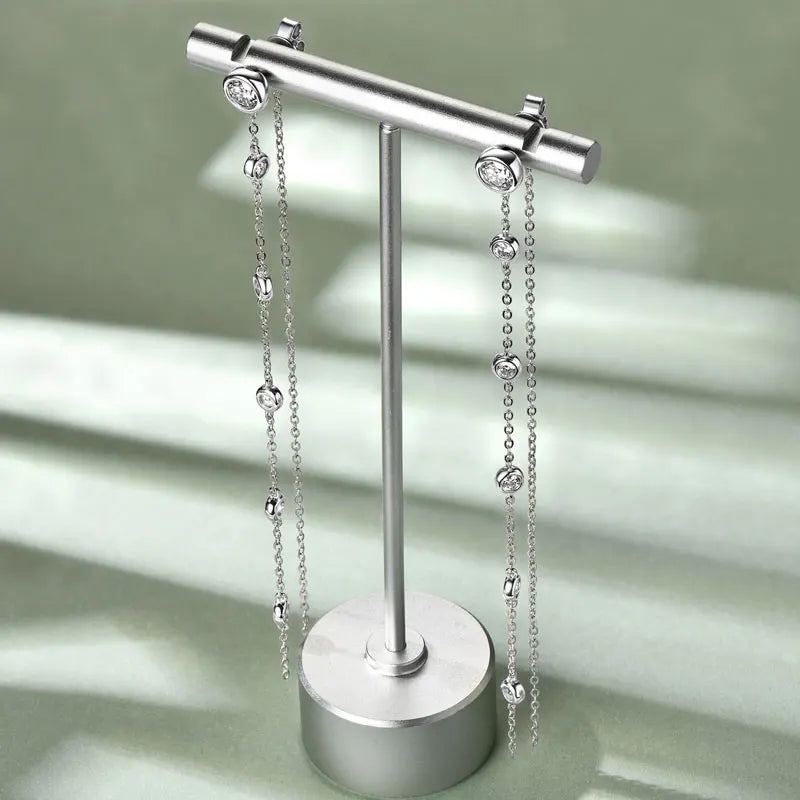 Long Moissanite Station Chain Earrings in Sterling Silver — Silver earrings on display stand