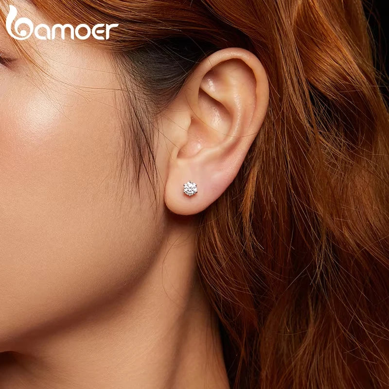 Round Moissanite Crown-Setting Stud Earrings in Sterling Silver — Shown on ear