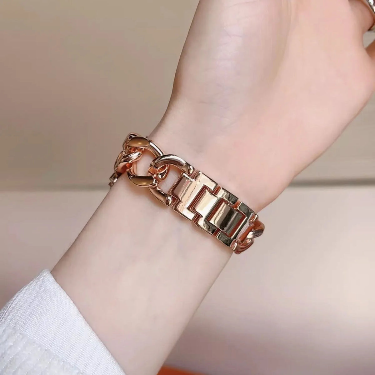 Rose gold-tone chain bracelet clasp worn on a wrist