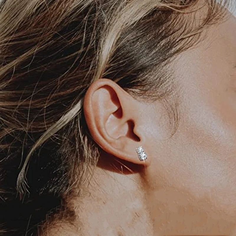 Graduated Two-Stone Moissanite Stud Earrings in Sterling Silver — Two-stone studs worn on the ear